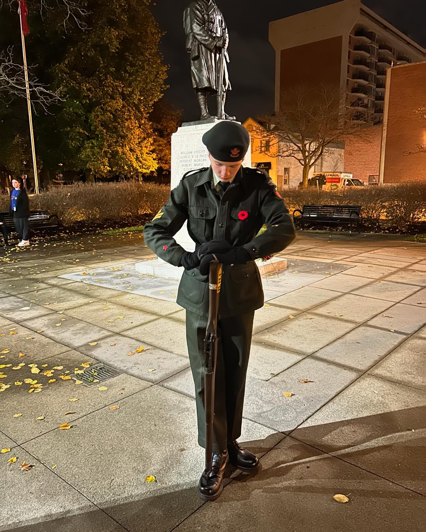 Cadet standing in front of the memorial during the ceremony