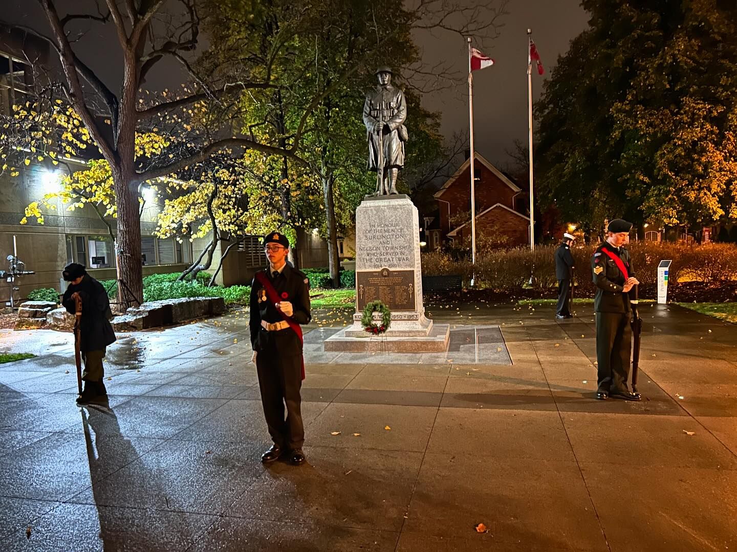 Cadet standing beside wreaths during the event