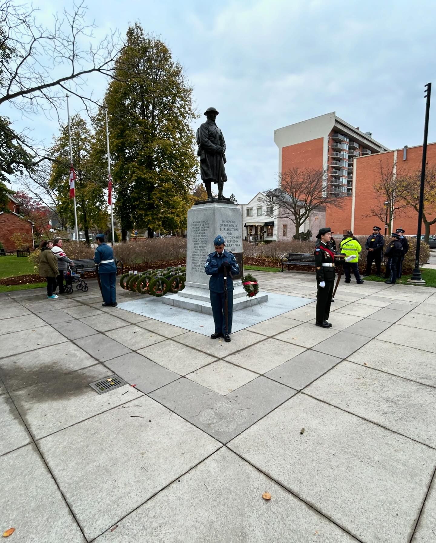 Cadet standing near wreaths and memorial stone