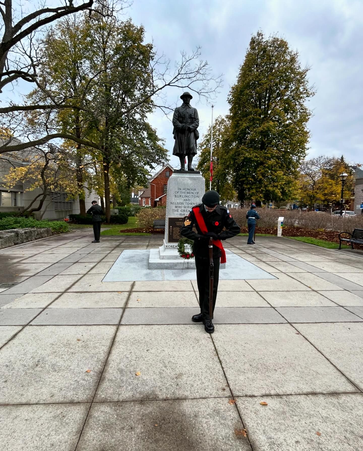 Night-time cadet guard posture in front of the memorial