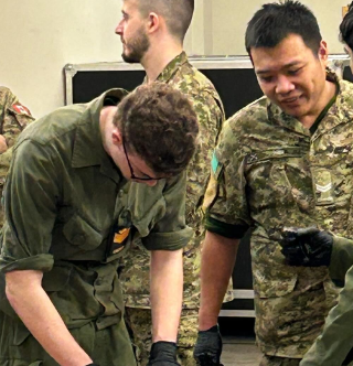 Rear perspective of cadets observing an instructor during the indoor activity
