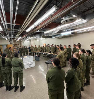 Cadets standing in formation and listening during the training session
