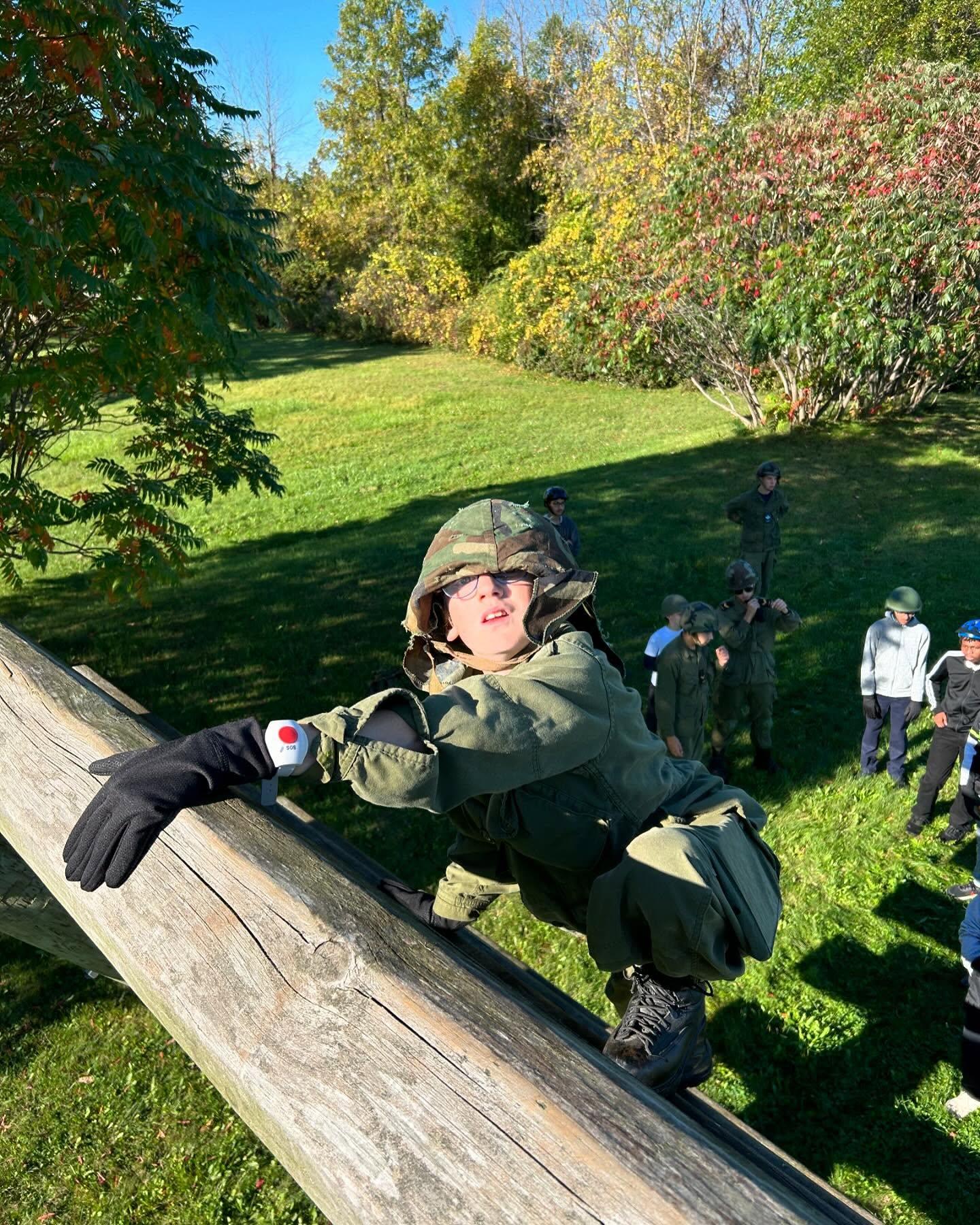 Close-up of a cadet navigating the challenge course timber frame